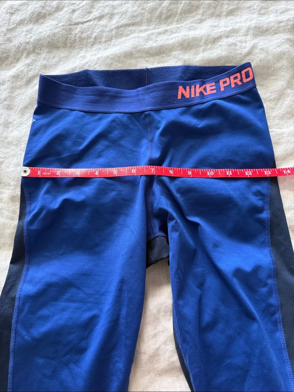 Nike Blue Cropped Leggings with Black Side Panels and Coral Accent